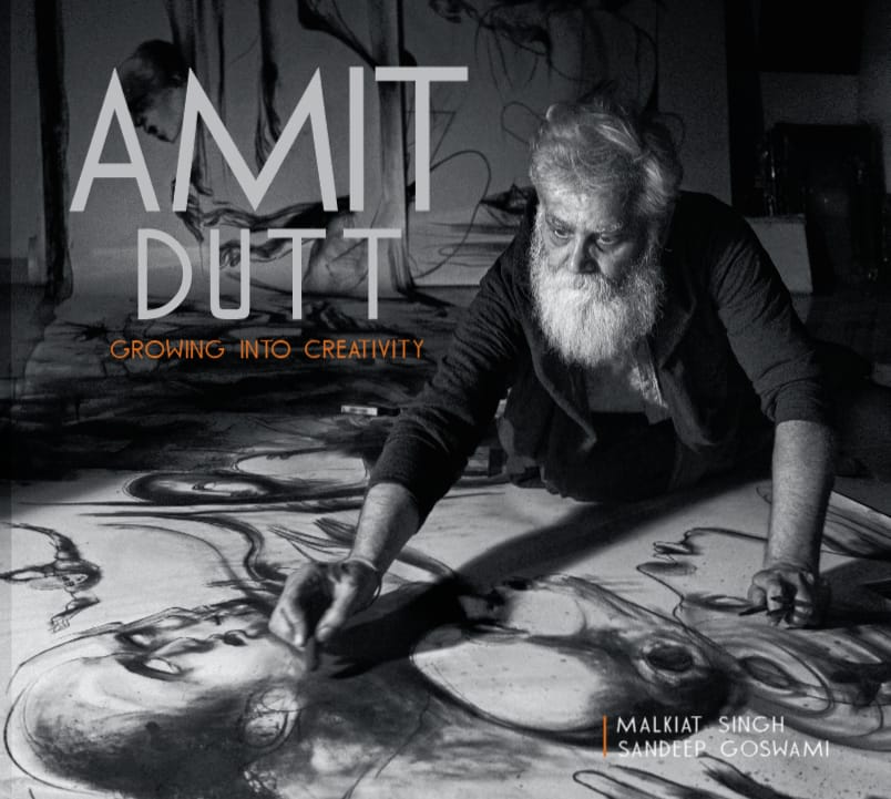 Cover of Amit Dutt: Growing into Creativity — the artist drawing on a large sheet on his studio floor